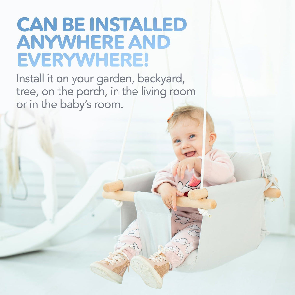 Gray canvas baby hanging swing seat with wooden support bars and hanging rope