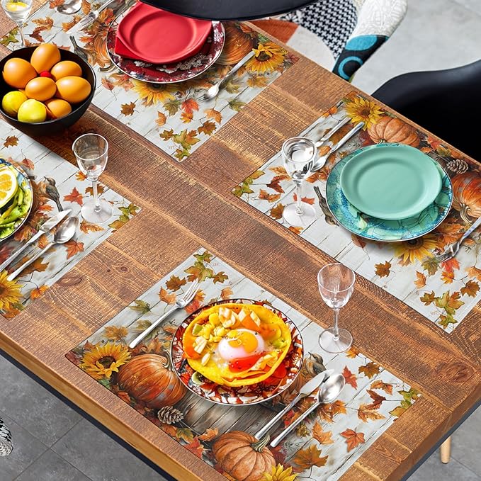 Cotton-linen placemats with pumpkin and leaf pattern on a table set with dishes and drinks
