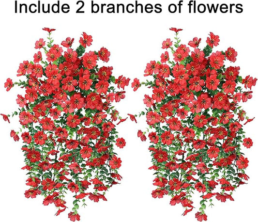 Two red faux hanging flower bundles with dense green vines and small red blossoms