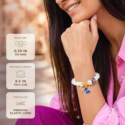 White agate bead bracelet with butterfly charms on wrist, blue and gold