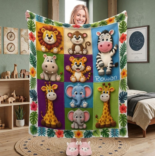 Kids safari animals blanket held up, featuring lion, zebra, elephant, and name "Rowan".