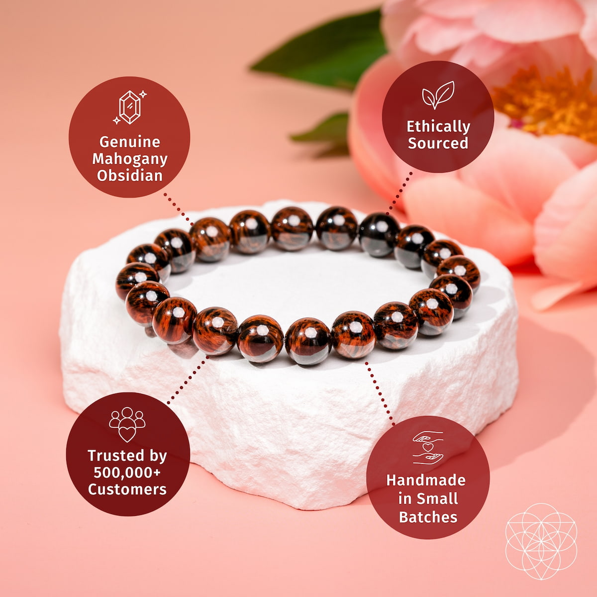 Mahogany and obsidian beaded bracelet on white cushion, brown and black round stones