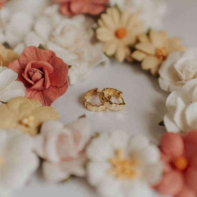 Pair of gold Tate hoop earrings with scalloped, ridged edges.