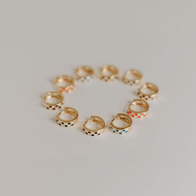 Gold checkered hoops in assorted enamel colors arranged in a circle