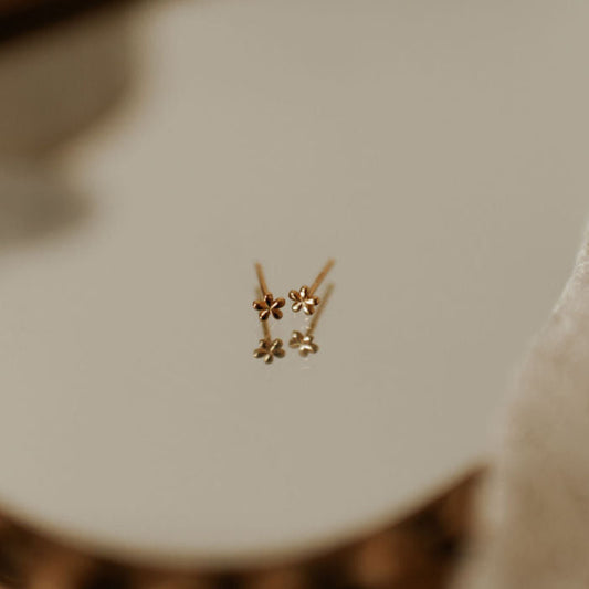 Pair of gold mini flower stud earrings with slim posts