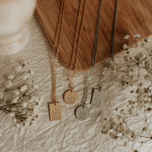 Four gold and silver necklaces with round and rectangular temple pendants