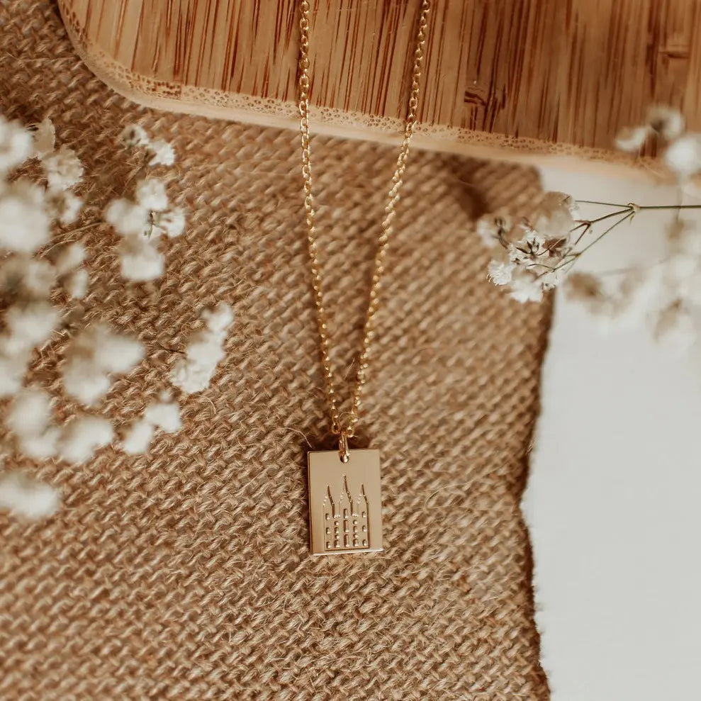 Gold necklace with a rectangular temple pendant on a fine chain