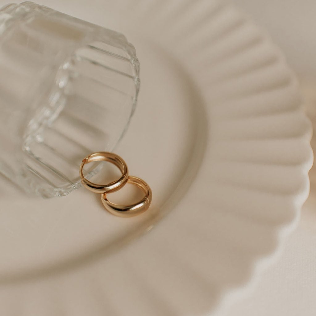 Pair of gold chunky hoop earrings with smooth bands