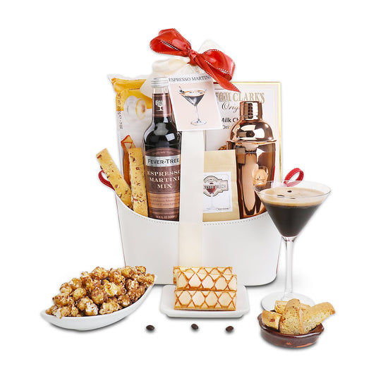 Espresso martini gift basket with bottles, chocolate treats, crackers, and a martini glass.