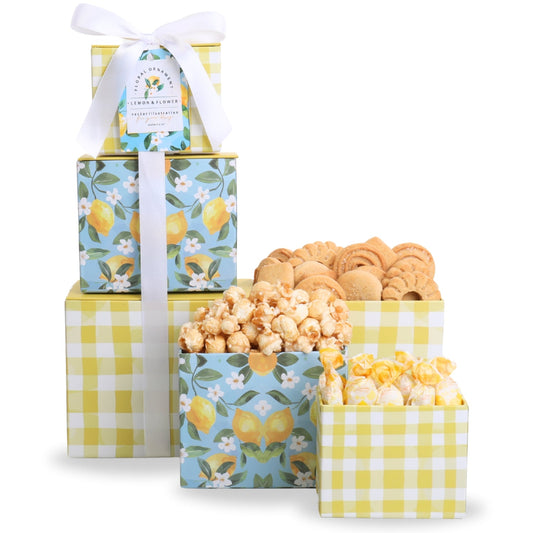 Gift tower set with yellow gingham boxes and blue floral wrap, white bow, assorted cookies