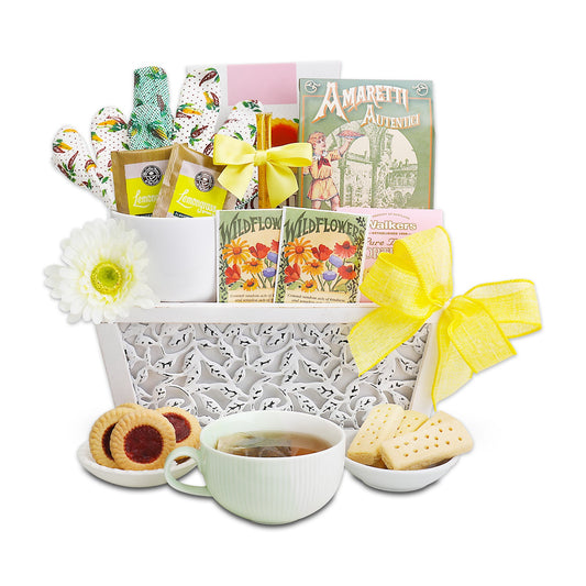 Cookies and tea gift basket with white insert, yellow bow, cup of tea and crackers
