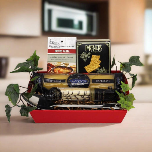 Red Italian gourmet gift basket with three pasta packs and two boxed pasta products
