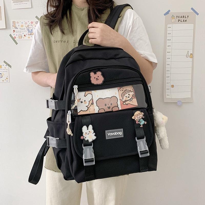Black mini backpack with front organizer pocket, cartoon bear charm and webbing straps