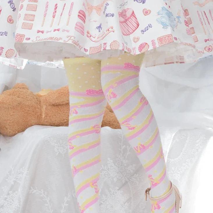 Knee-high socks with pastel pink and yellow rainbow stripes and small heart print