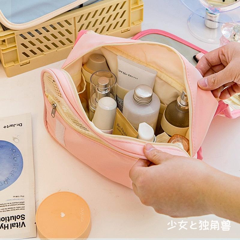 Pink makeup bag open with inner zip pockets and mesh panel
