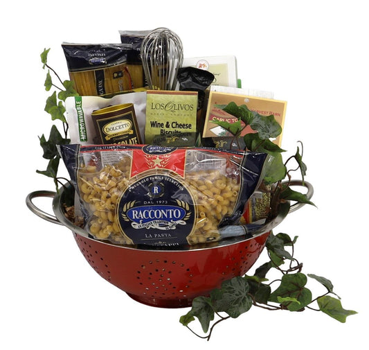 Italian gift basket in red metal colander with wine-and-cheese biscuits and pasta