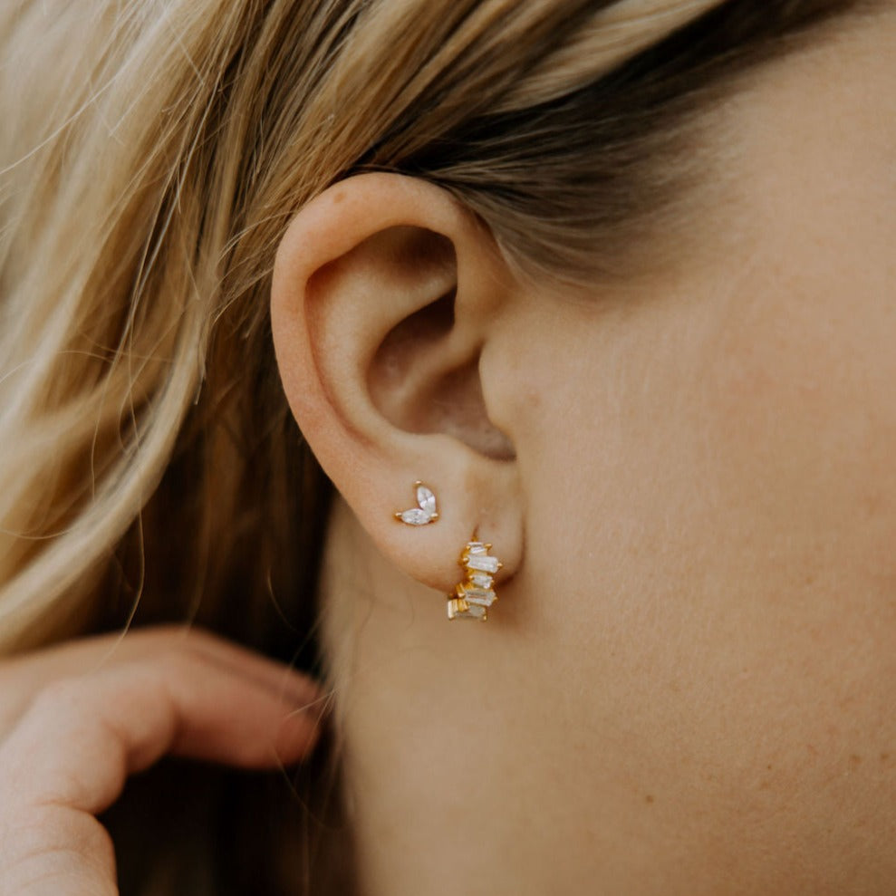 Quinn diamond heart stud worn above a gold drop earring