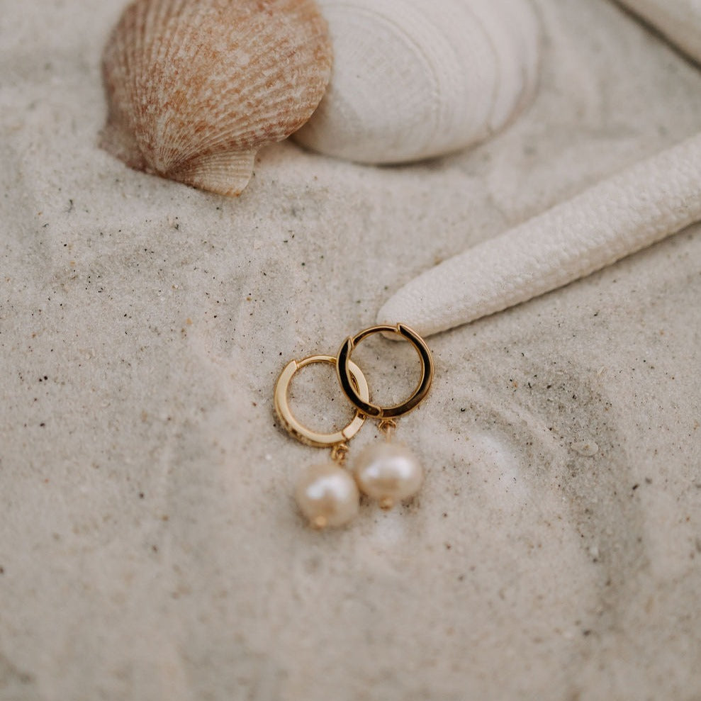 Pair of Bondi Pearl gold hoop earrings with dangling white pearls