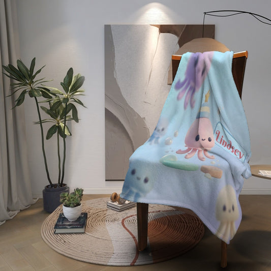 Octopus-themed light blue blanket draped over chair with octopus and Lindsey logo-style print
