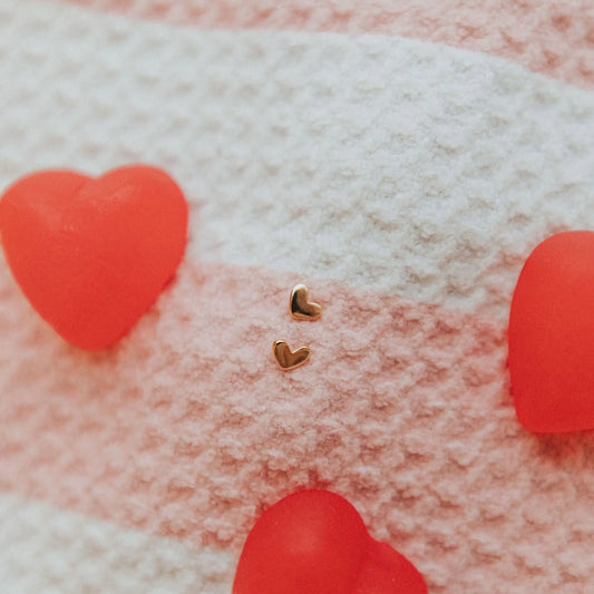 Pair of small gold heart stud earrings