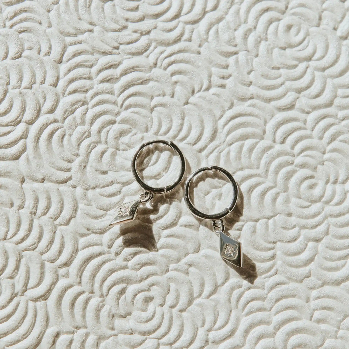 Silver Nova Hoops with dangling diamond-shaped charms