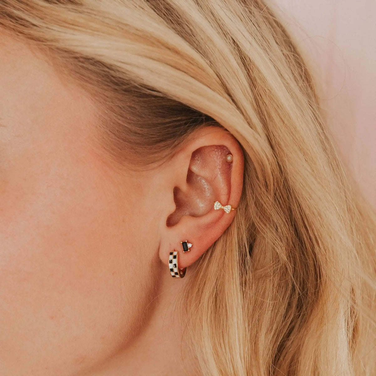 Mini bow ear cuff with clear stones worn on the upper ear