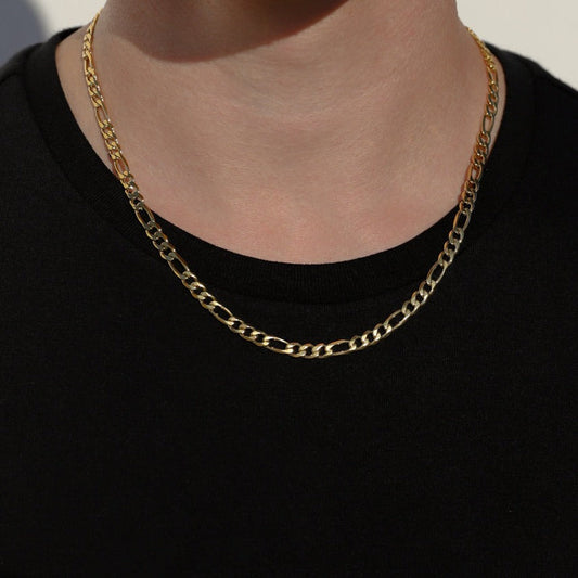 Gold-tone Figaro chain necklace on neck, oval links