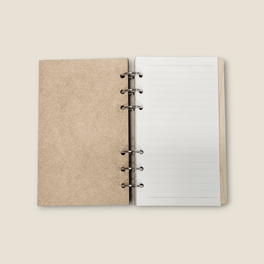 Wood refillable notebook open with blank lined pages and metal binder rings