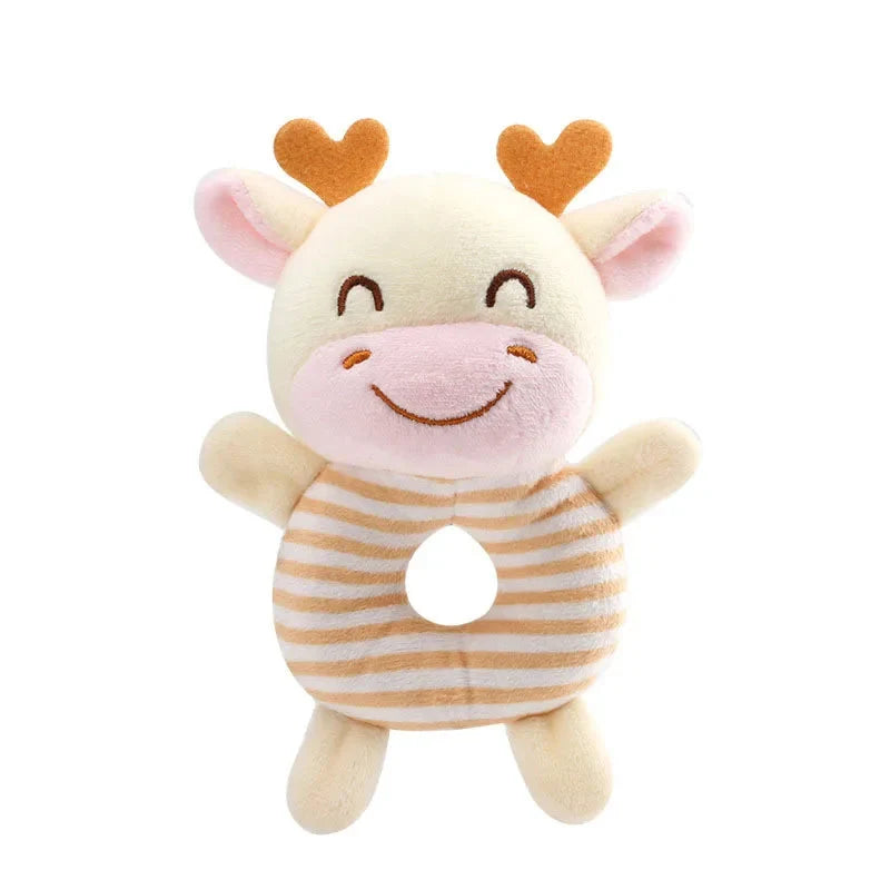 Cream cow plush ring rattle toy with striped outfit, orange heart ear accents