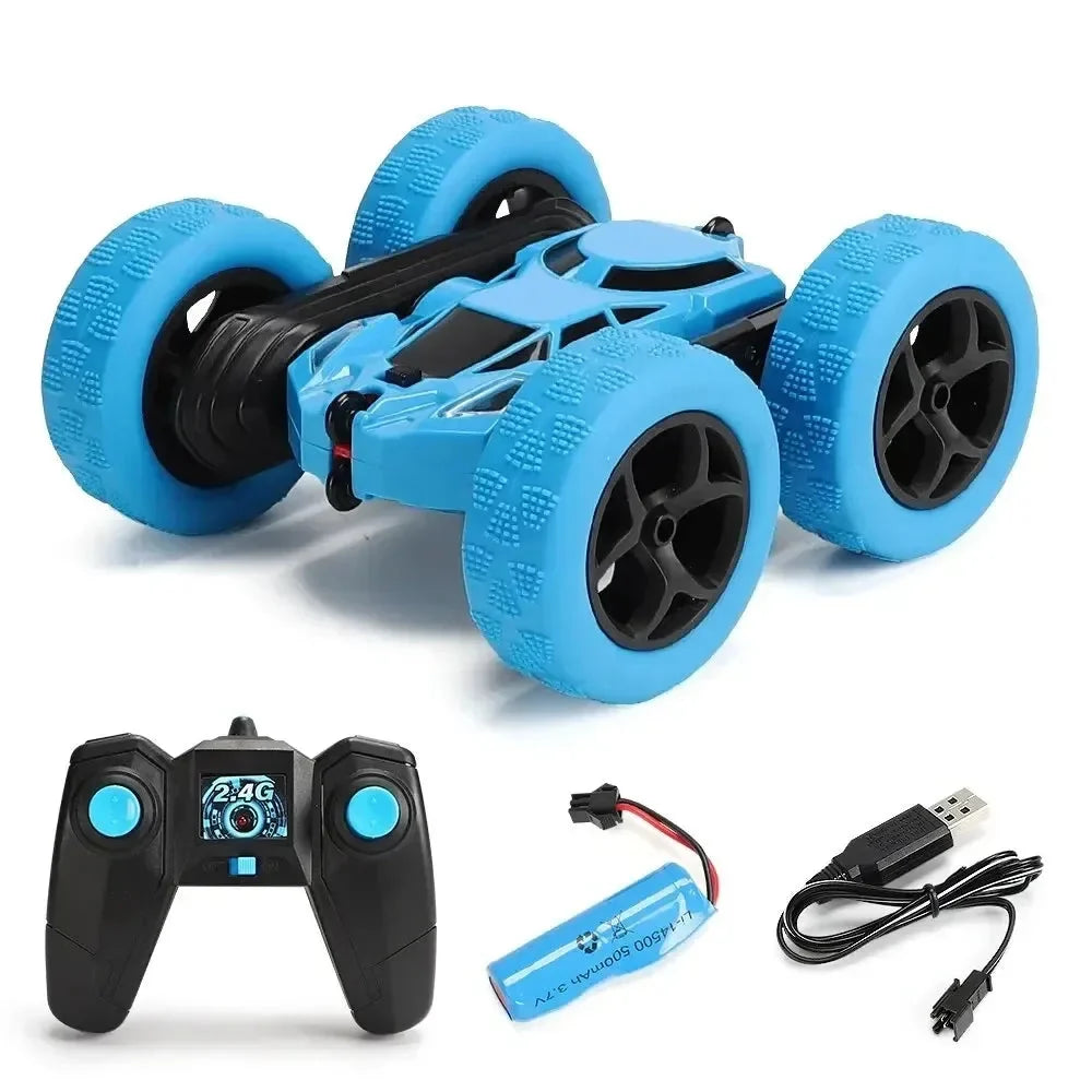 Blue RC stunt car with oversized foam tires and 2.4G remote controller