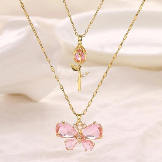Gold-tone butterfly rose necklace with small pink rose charm and pink butterfly centerpiece