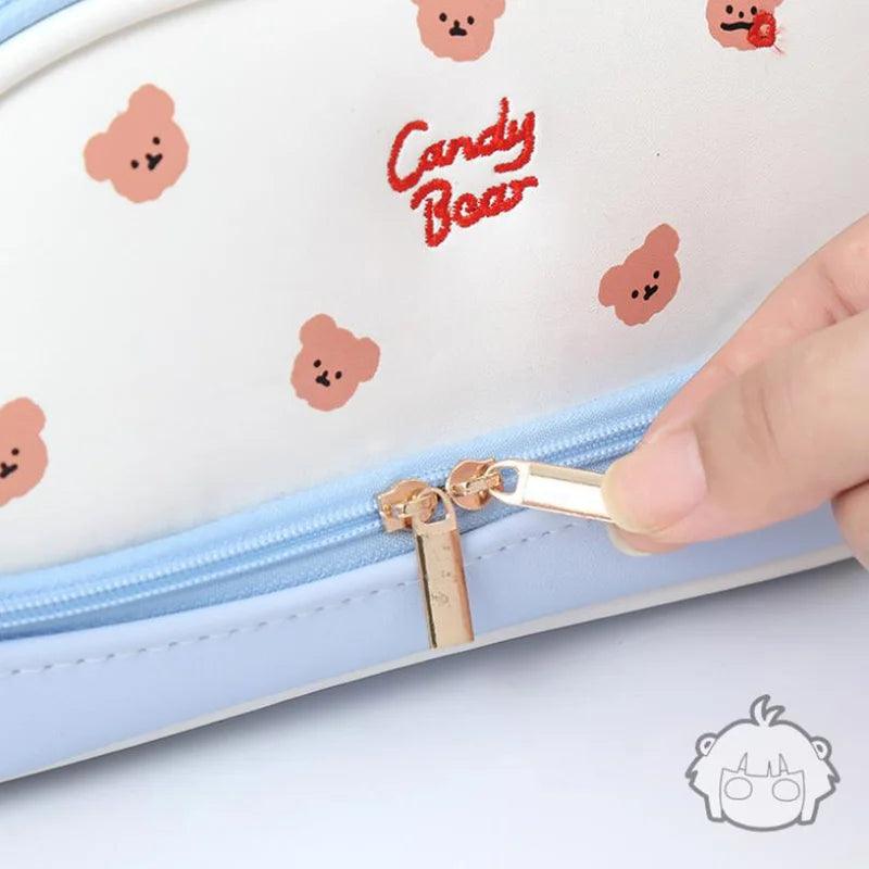 Double-compartment pencil bag closeup, light blue with zipper and bear pattern