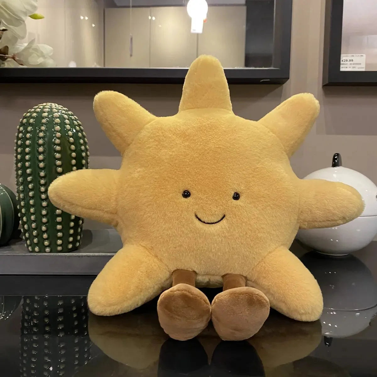 Smiling yellow sun plush stuffed pillow with rounded paws and stitched smile