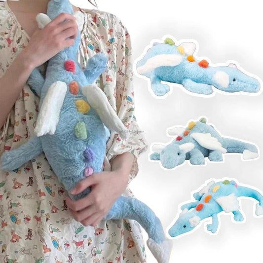 Rainbow dragon plush toy held by a person, light blue plush with white belly and tail