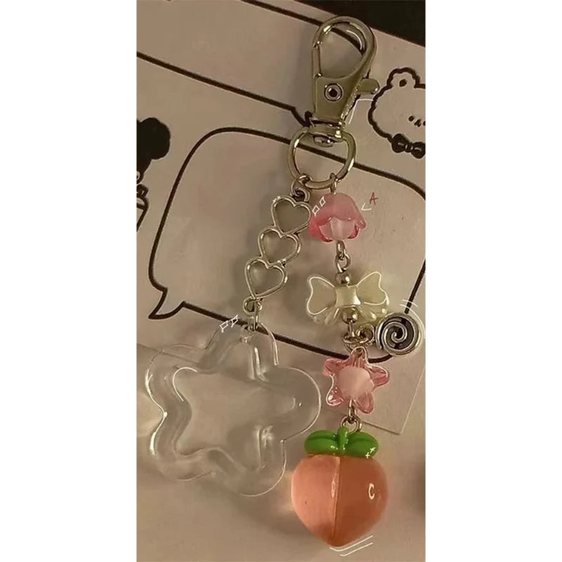 Peach kawaii keychain charm with clear animal silhouette, pink flower, and spiral link