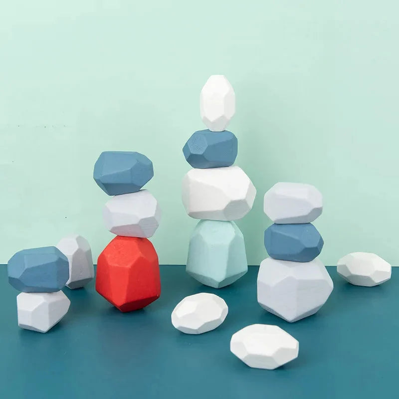 Wooden stacking rocks with faceted hexagon pieces, white and blue with one red center rock