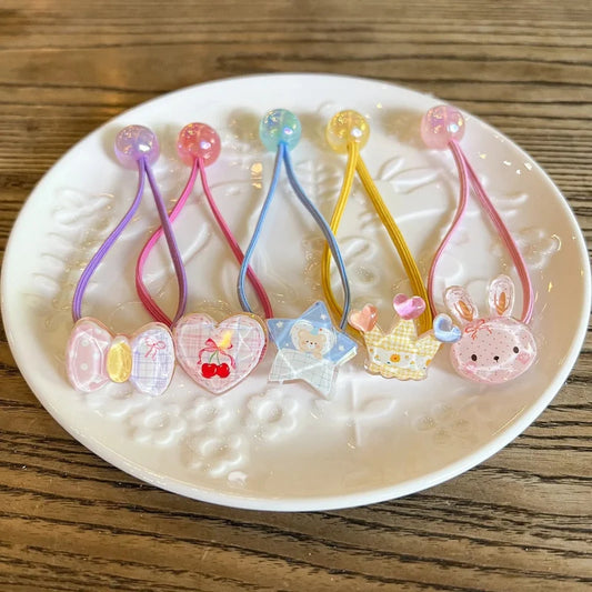 Pastel elastic hair ties with bunny and star charms, linked by looped elastic cords