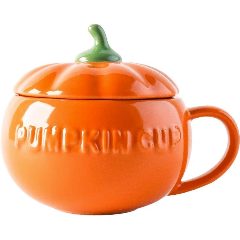 Orange pumpkin-shaped ceramic mug with green stem lid and embossed lettering