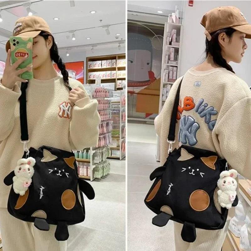 Black cat-shaped messenger bag with brown ear accents and full-body cat legs design