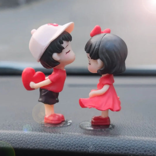 Car dashboard couple ornament figurine, two characters facing each other in red outfits