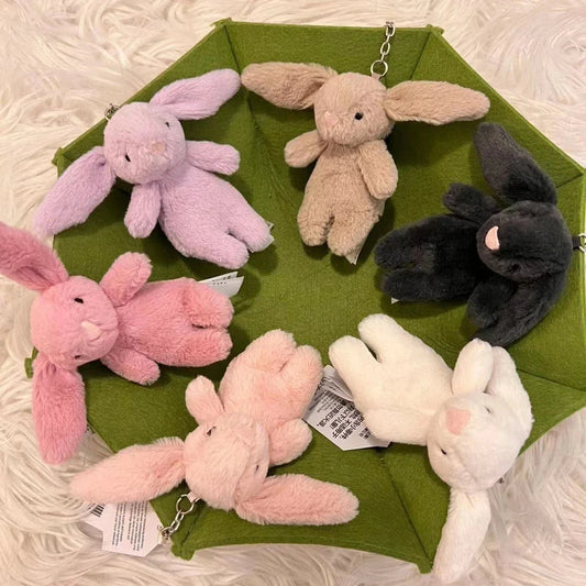 Set of rabbit plush keychains in pink, purple, beige, and black with silver chains