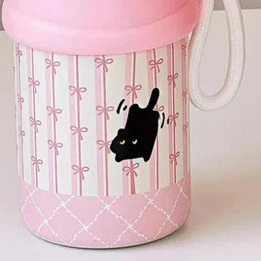 Pink thermos bottle with black cat graphic on striped ribbon design