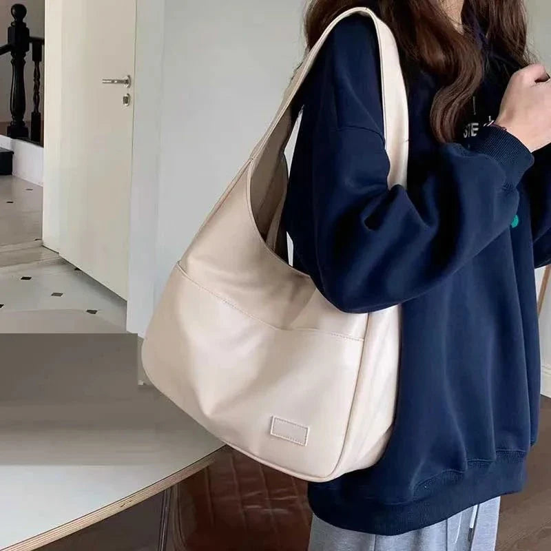 Cream leather shoulder tote bag with wide straps and front patch pocket