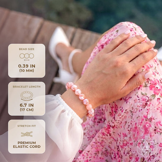 Peach-pink agate bead stretch bracelet worn on wrist with round beads