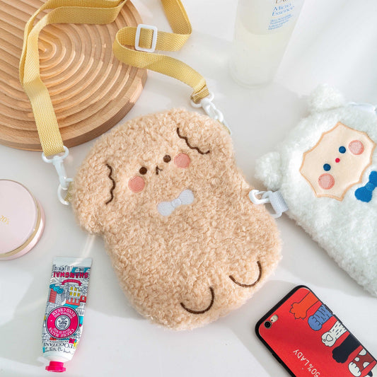 Tan plush bear crossbody bag with stitched face and adjustable shoulder strap