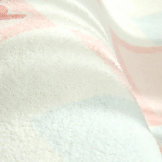 Pastel striped plush rug pile close-up with light blue and pink tones.