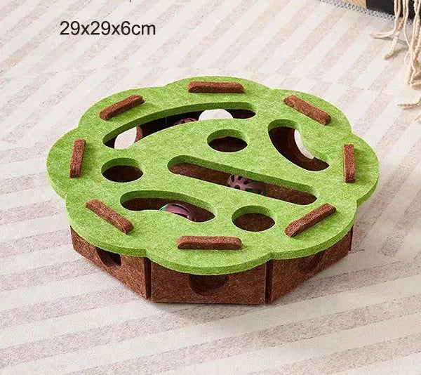 Green felt maze puzzle box with curved tunnels, paw-print cutouts, and ball openings.
