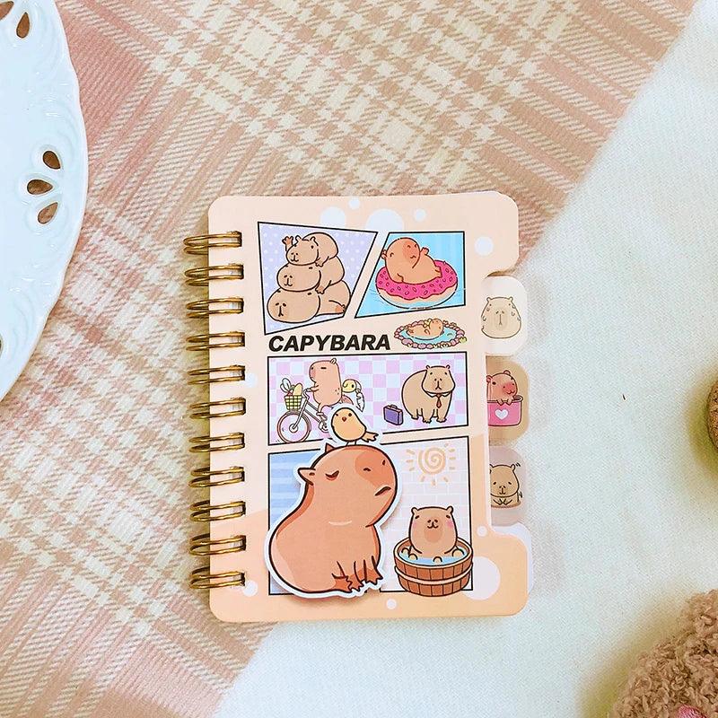 Capybara mini notebook with colorful cartoon cover, gold spiral binding, sticker-style panels