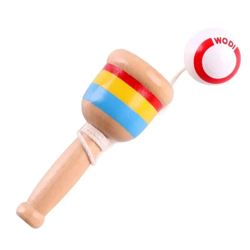 Close-up of striped wooden skill cup toy with red throw ball on string