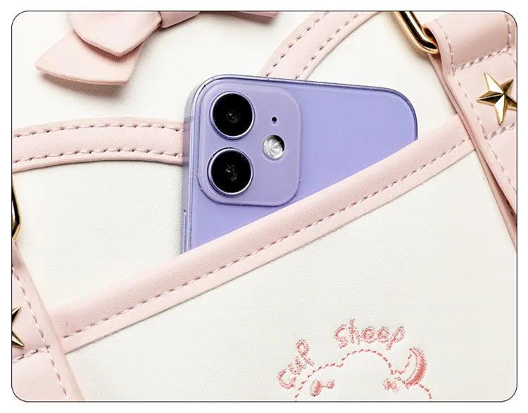 Kawaii messenger bag interior pocket holding a purple phone, with stitched pink trim edge